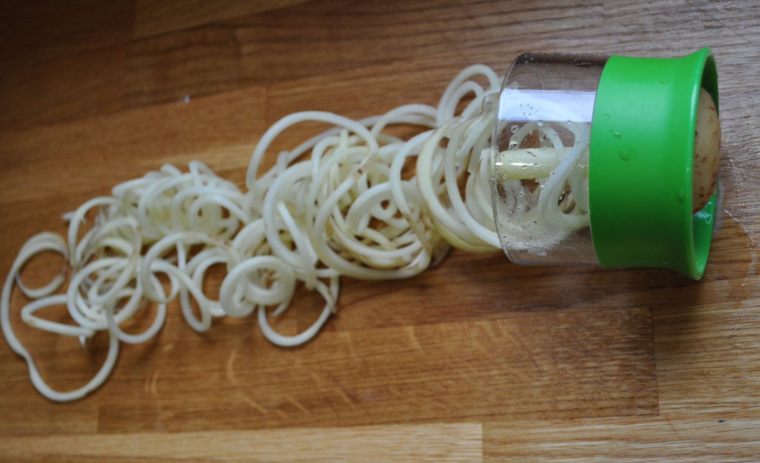Potatoes going through the OXO handheld Spiralizer